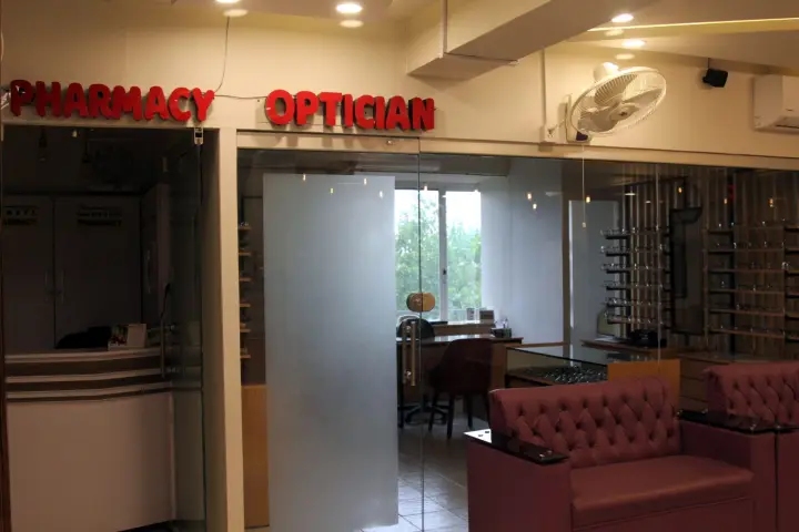 Pharmacy and optician counters with frames on display.